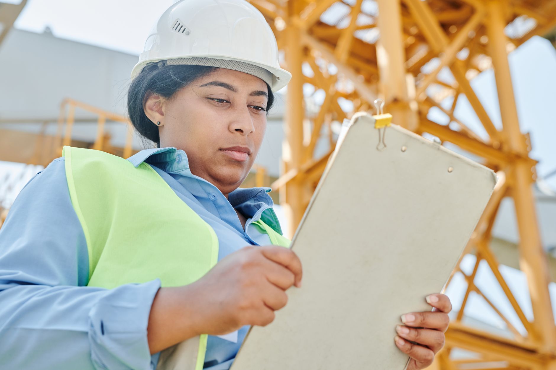 Land surveyor with tripod equipment at a construction site